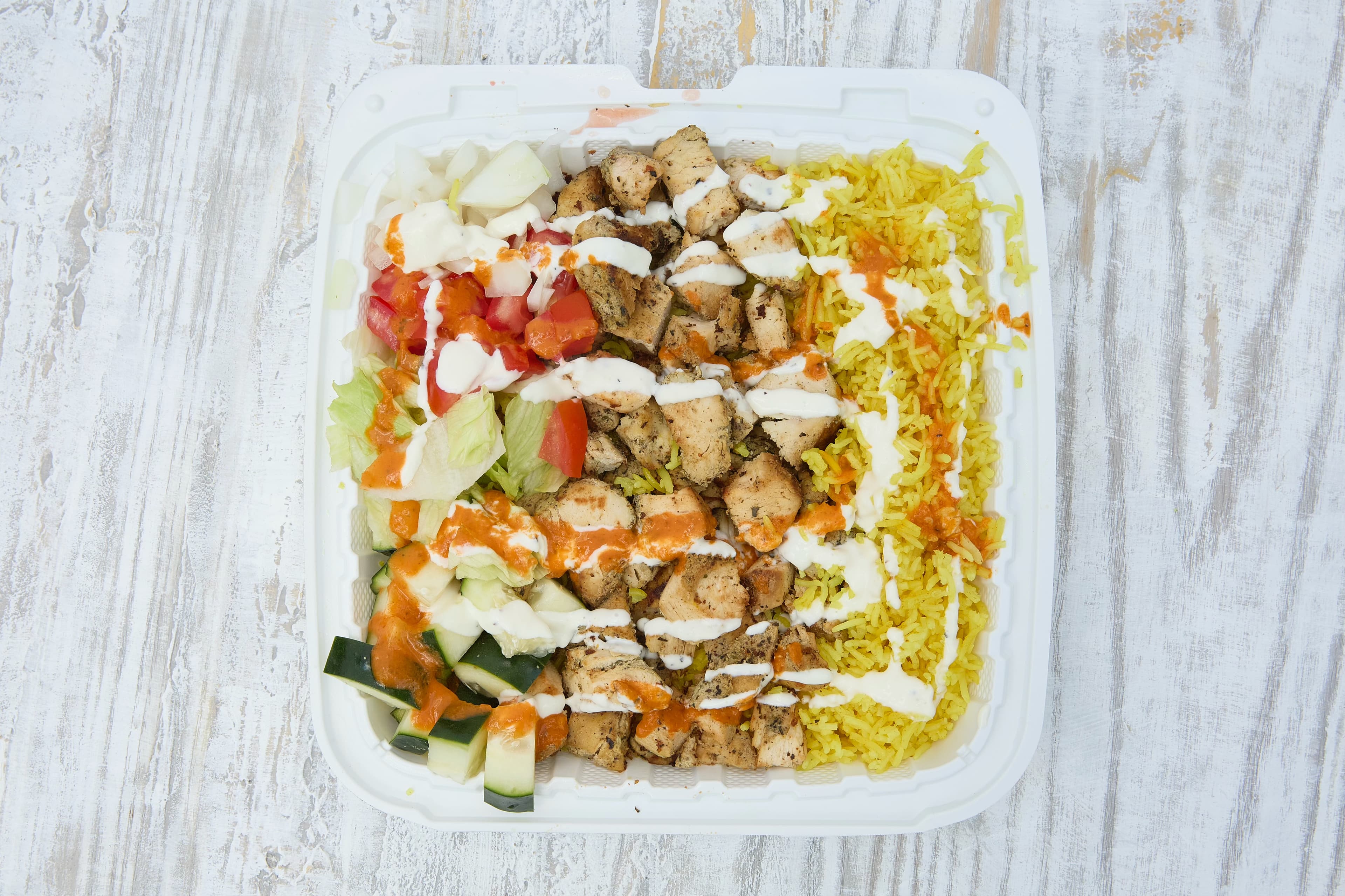 Delicious chicken over rice with white sauce